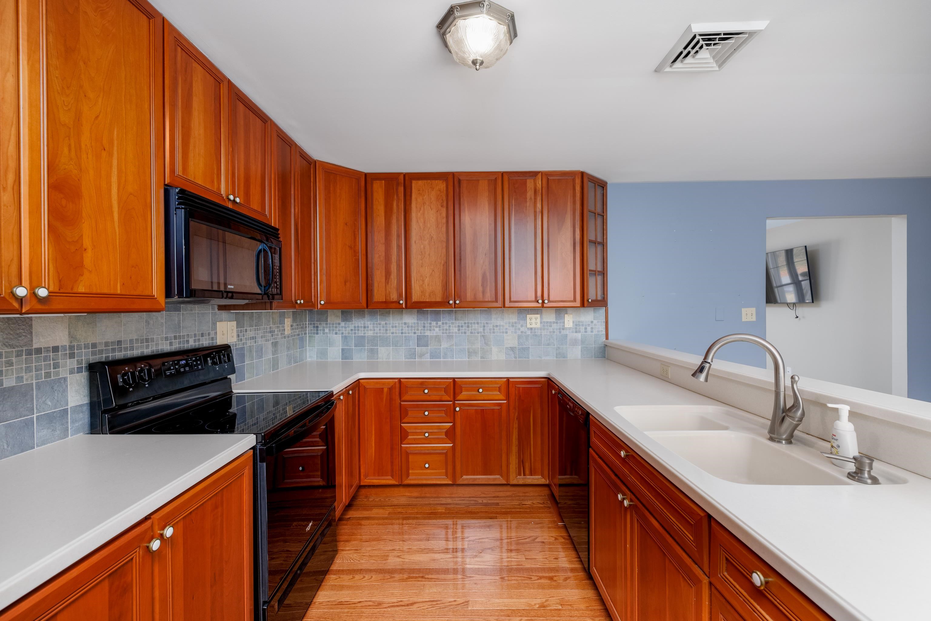 880 Honeysuckle Road Erma, NJ 08204 - Photo 12 of 31 a kitchen with stainless steel appliances granite countertop a sink stove and microwave