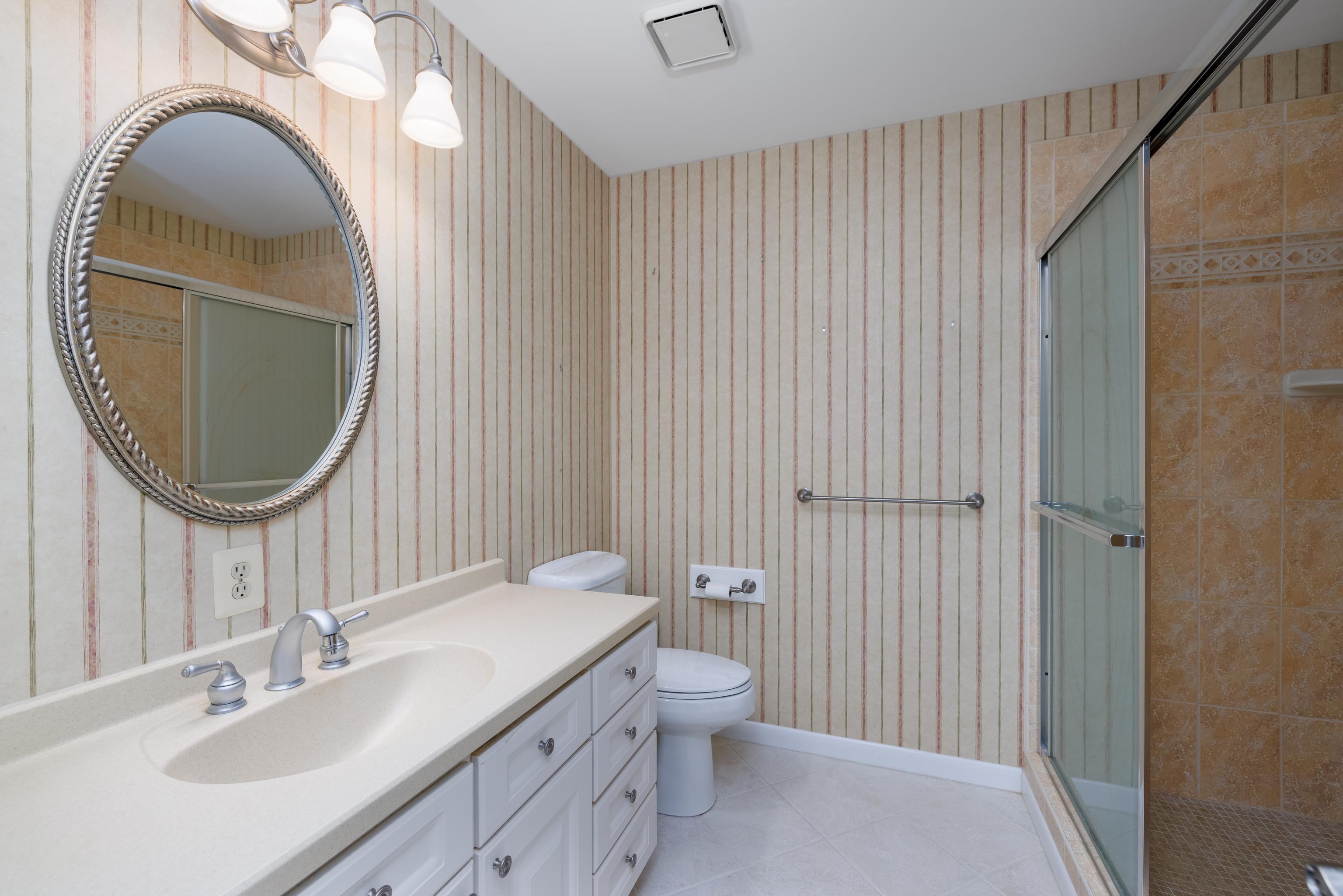 880 Honeysuckle Road Erma, NJ 08204 - Photo 15 of 31 a bathroom with a sink a toilet and a mirror