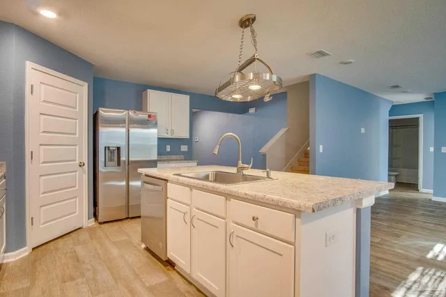a kitchen with a refrigerator and countertop