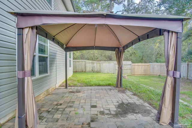 a view of a backyard with a barn and large trees