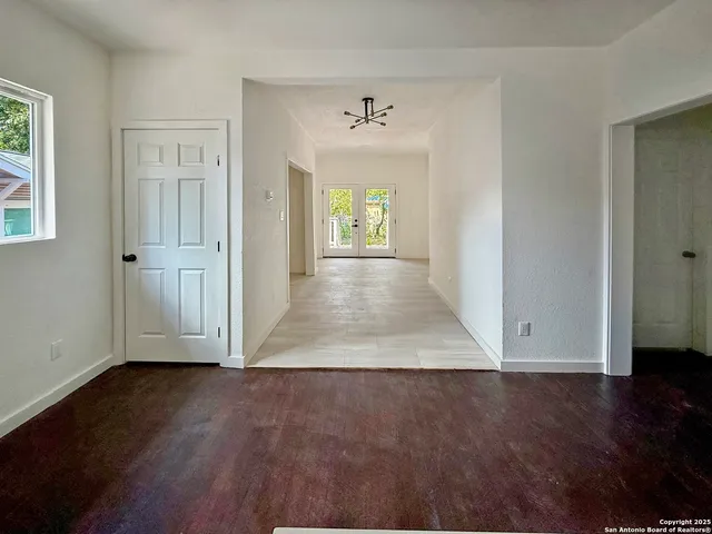 a view of a room with wooden floor