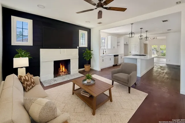 a living room with furniture fireplace and a flat screen tv