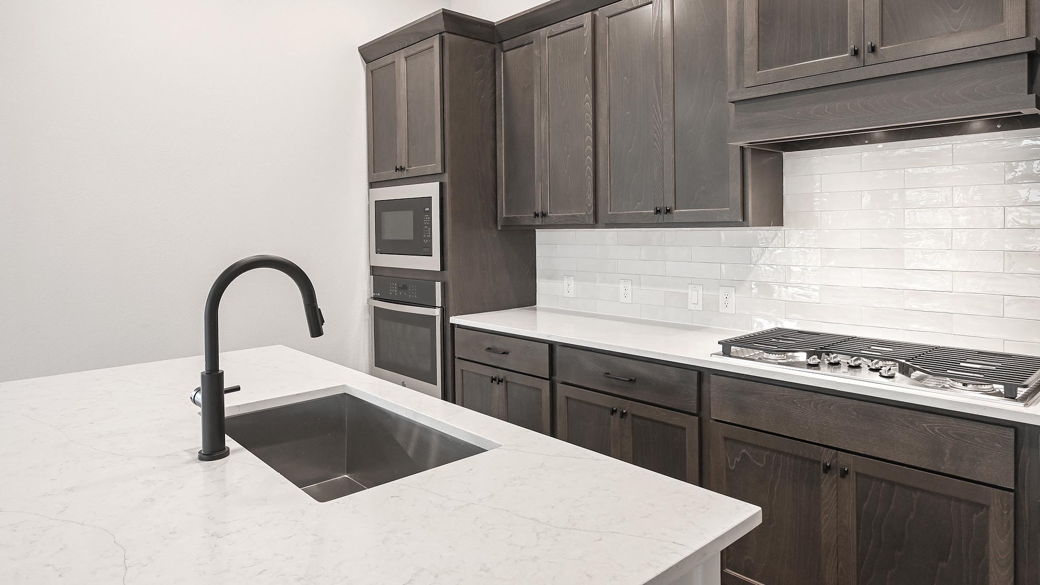 126 Basket Flower Loop Kyle, TX 78640 - Photo 10 of 29 a kitchen with a stove a sink and a window