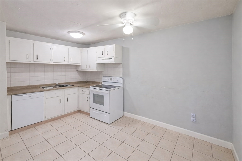 2 Universal Street, Unit 4 Framingham, MA 01702 - Photo 6 of 18 a kitchen with white cabinets and white appliances