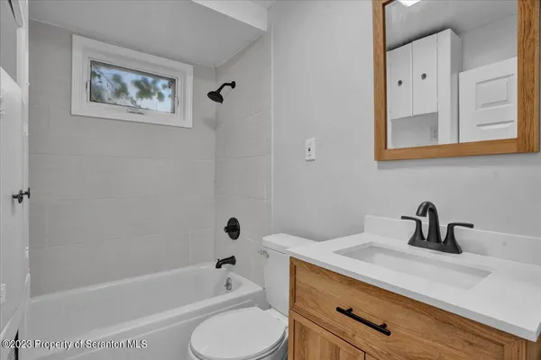 a bathroom with a sink a toilet and bathtub