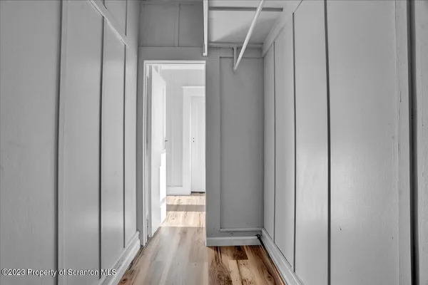 a view of a hallway with wooden floor