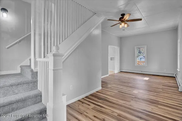 a view of an empty room and wooden floor