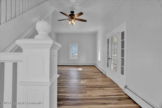 a view of an entryway with wooden floor