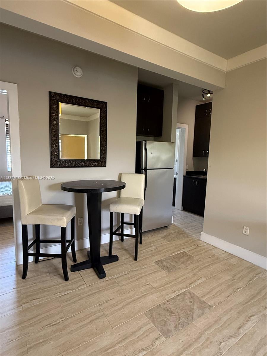 1330 Pennsylvania Avenue, Unit 313 Miami Beach, FL 33139 - Photo 11 of 14 a workspace with furniture wooden floor and windows