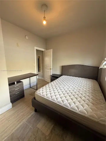 a bedroom with bed and window