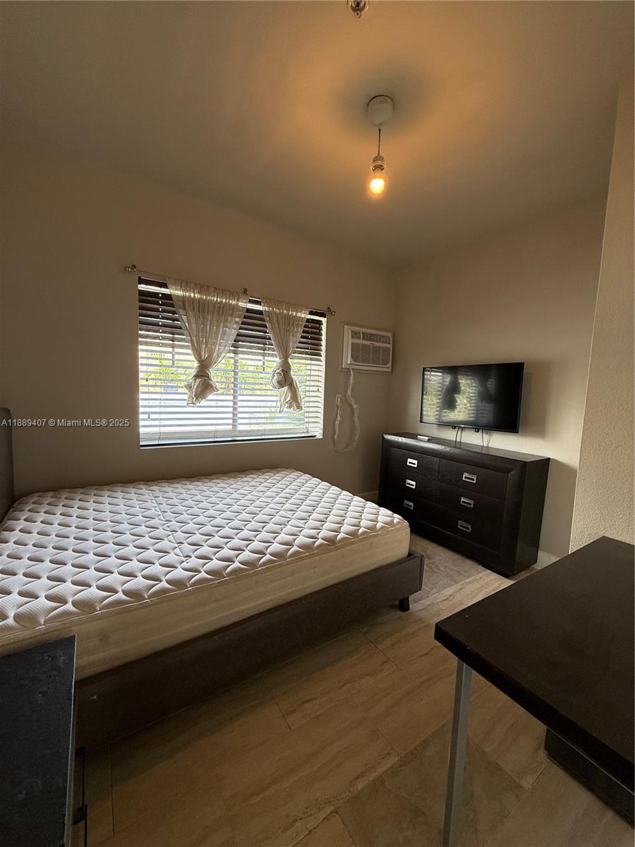 1330 Pennsylvania Avenue, Unit 313 Miami Beach, FL 33139 - Photo 13 of 14 a bedroom with a bed and a window