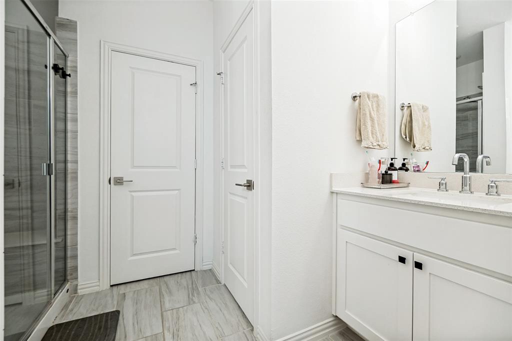 7536 Laburnam Road Dallas, TX 75228 - Photo 23 of 23 Dual vanity with undermount sinks, stone countertop, and chrome fixtures