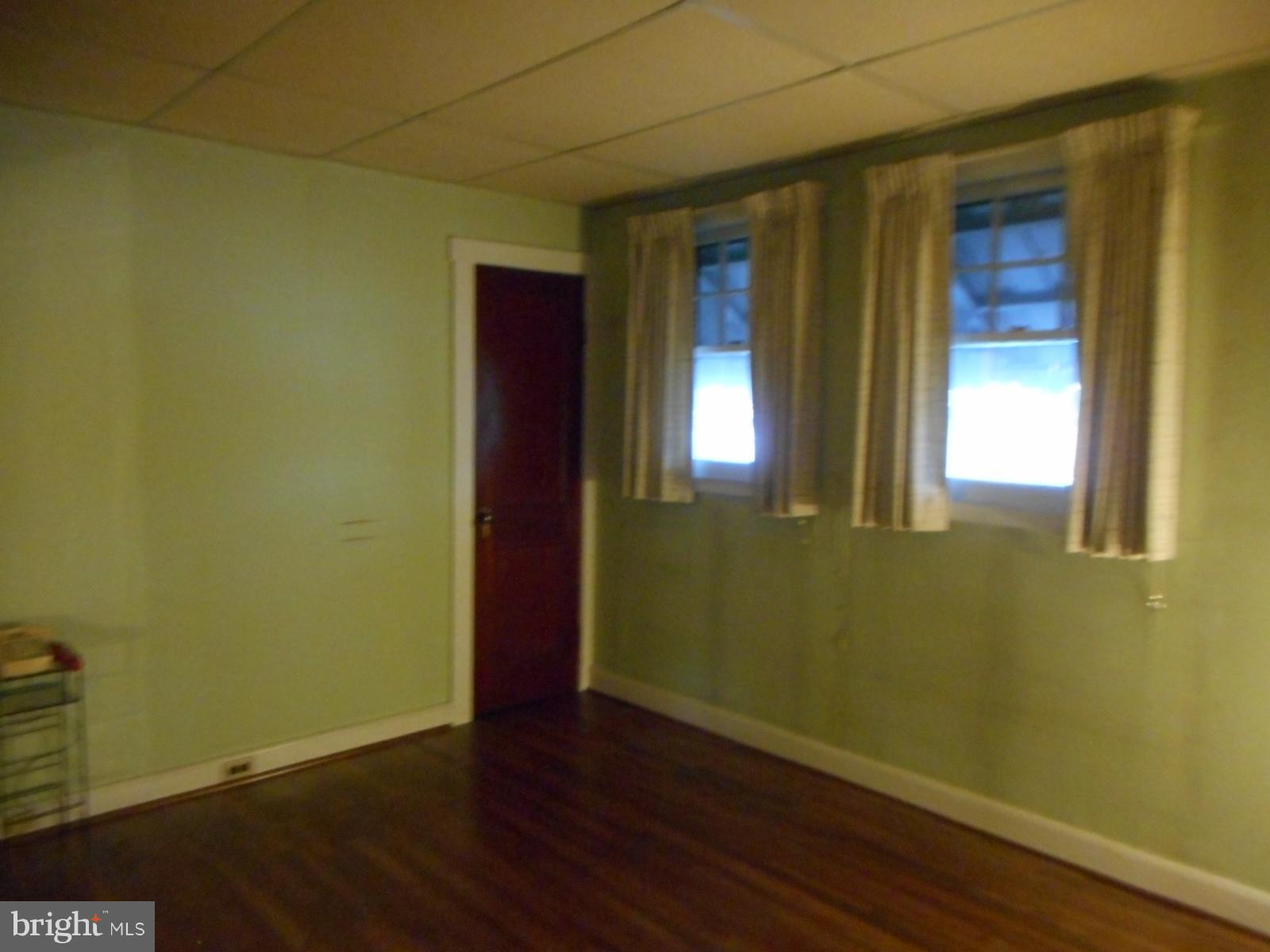 6501 Windsor Mill Road Baltimore, MD 21207 - Photo 13 of 17 an empty room with wooden floor and windows