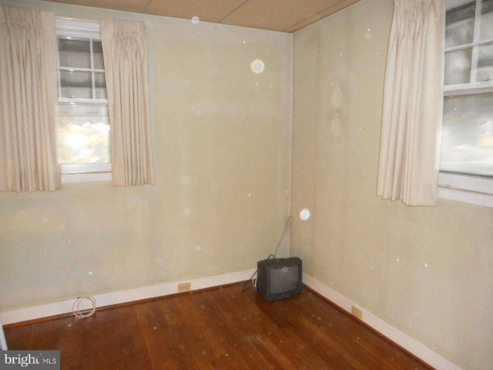 6501 Windsor Mill Road Baltimore, MD 21207 - Photo 14 of 17 a view of an empty room with wooden floor and a window