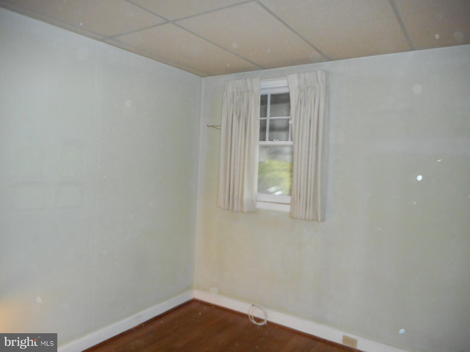 6501 Windsor Mill Road Baltimore, MD 21207 - Photo 15 of 17 a view of an empty room with wooden floor and a window