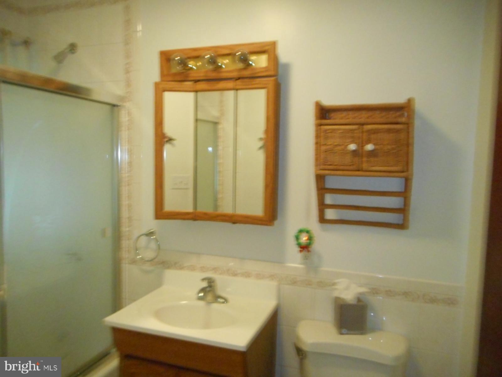 6501 Windsor Mill Road Baltimore, MD 21207 - Photo 17 of 17 a bathroom with a sink a toilet and a mirror