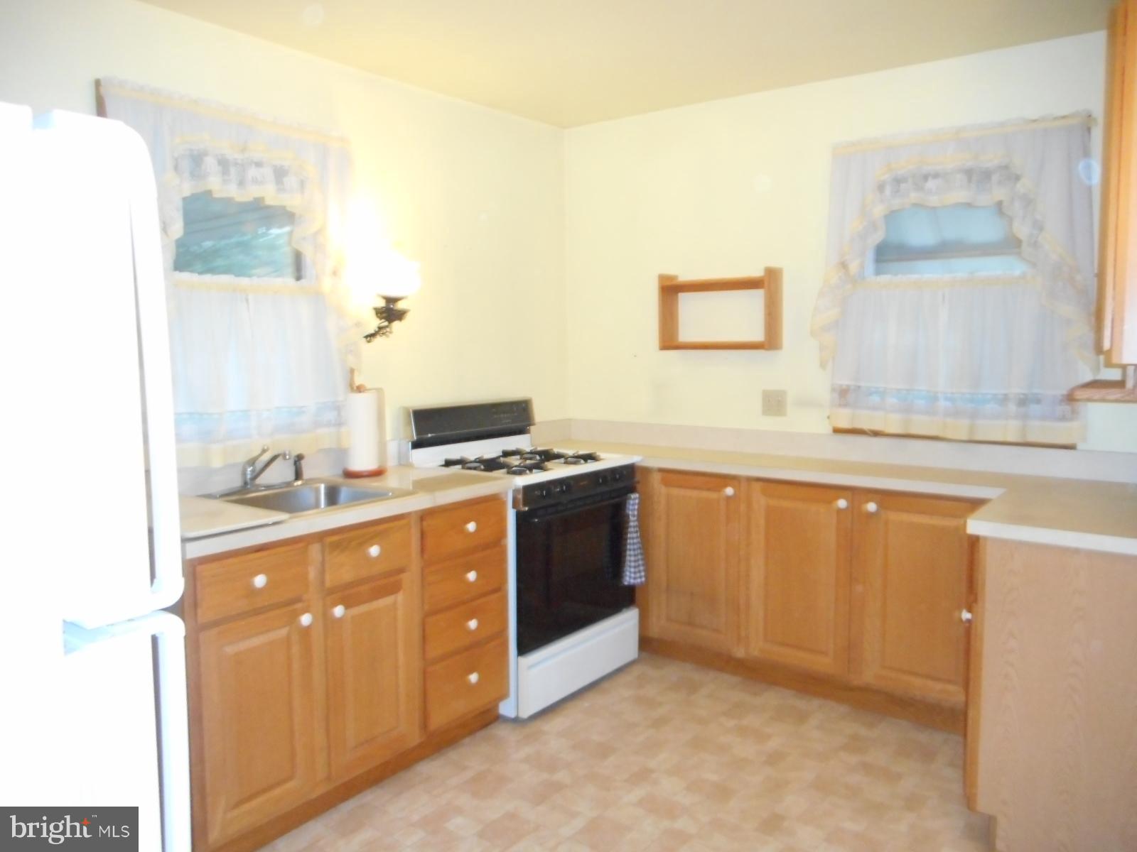 6501 Windsor Mill Road Baltimore, MD 21207 - Photo 5 of 17 a kitchen with stainless steel appliances granite countertop a sink and a stove