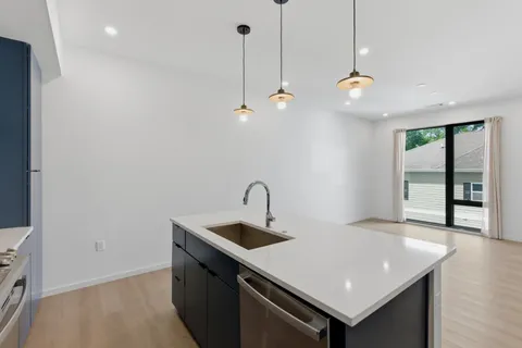 a view of a kitchen counter space a sink and appliances
