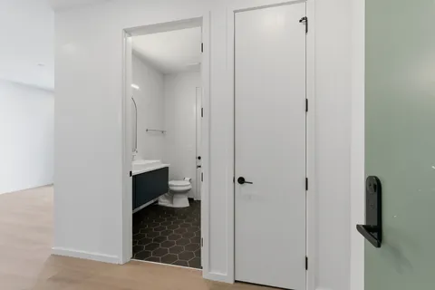 a bathroom with a granite countertop toilet and sink