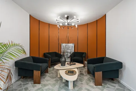 a view of a livingroom with furniture and floor to ceiling window