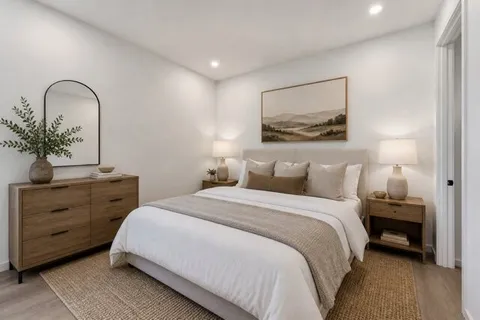 a bedroom with a bed and a potted plant