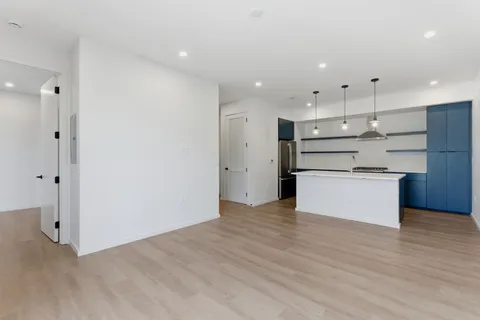 a view of kitchen refrigerator and cabinets