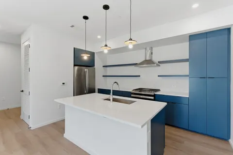 a kitchen with stainless steel appliances a sink a counter space and cabinets