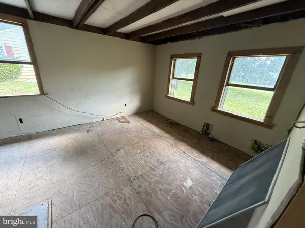 a view of a livingroom with furniture and a window