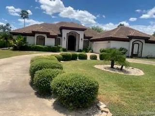 a front view of a house with garden