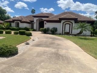 604 Avenida Morelos Rancho Viejo, TX 78575 - Photo 2 of 14 a front view of a house with garden