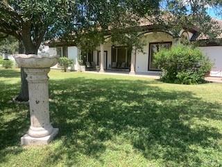 604 Avenida Morelos Rancho Viejo, TX 78575 - Photo 3 of 14 a view of a house with a yard and fountain
