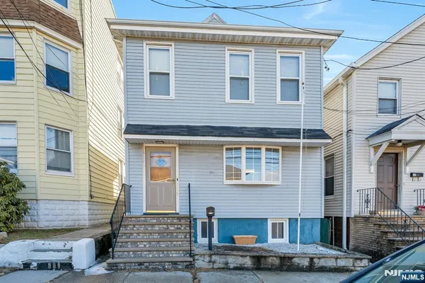 a front view of a house with stairs