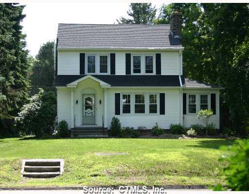 a view of a house with a yard and plants