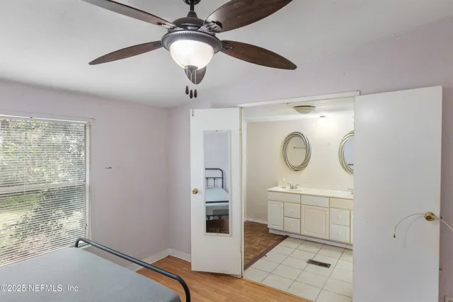 a view of a livingroom with wooden floor and a ceiling fan