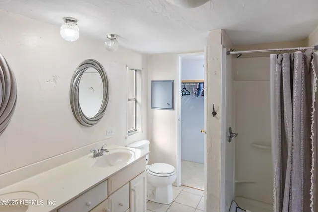 a bathroom with a toilet a sink and a mirror