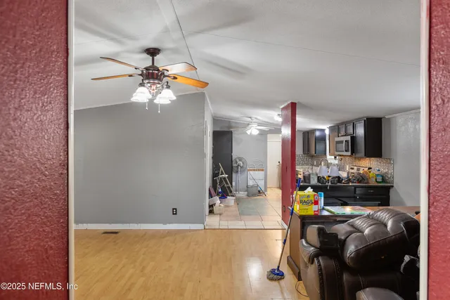 a living room with furniture and chandelier