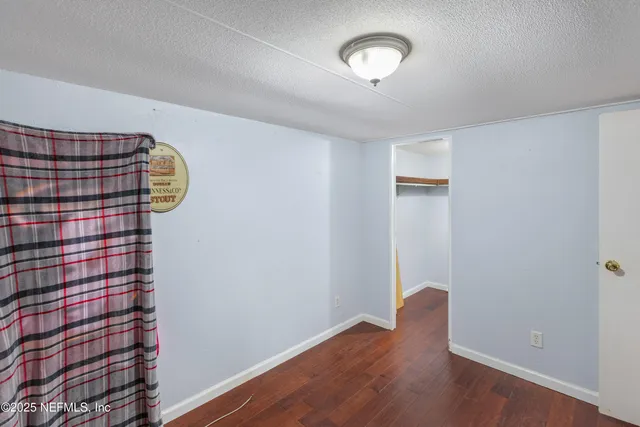 wooden floor in a hall with a window