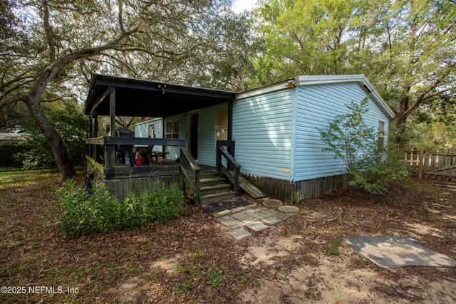 a backyard of a house with barbeque oven