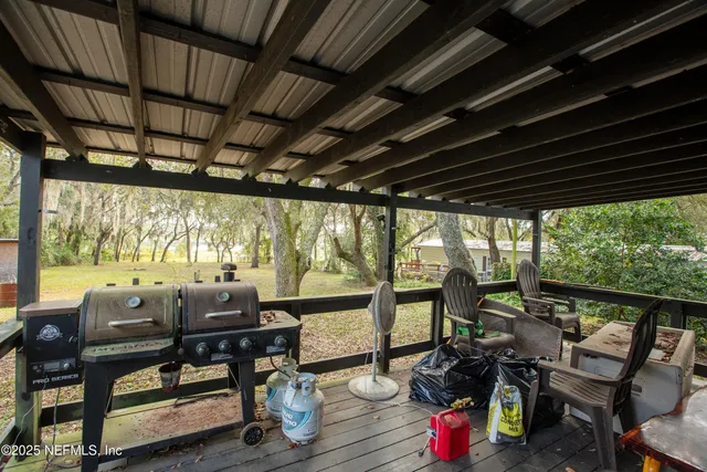 a view of a porch with furniture and wooden floor