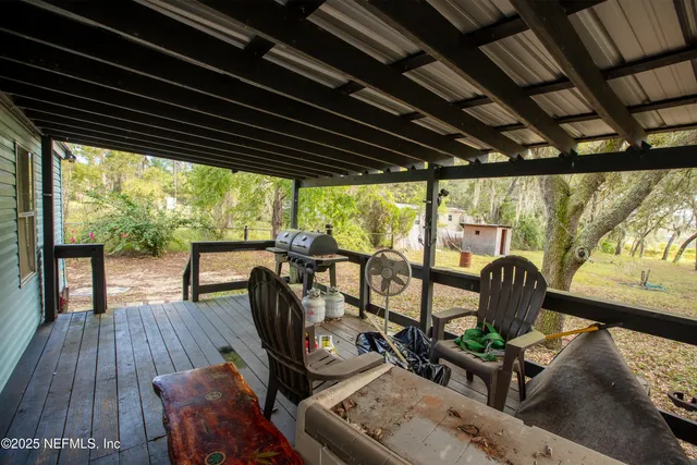 a view of a porch with furniture and wooden floor
