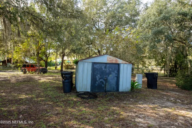 a wooden house with trees in front of it