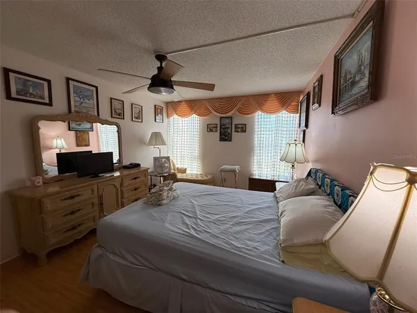 a bedroom with furniture and a flat screen tv