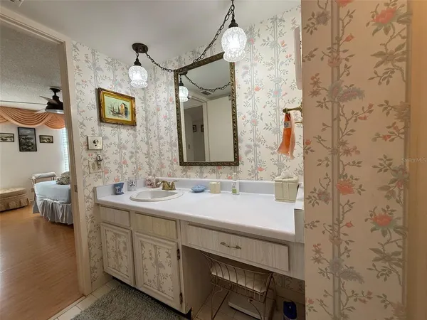 a spacious bathroom with a double vanity sink and a mirror