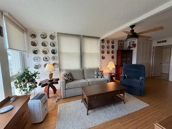 a living room with furniture and wooden floor