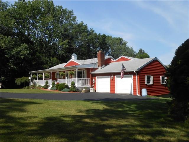 100 Isinglass Road Shelton, CT 06484 - Photo 1 of 1 a front view of a house with a yard table and chairs