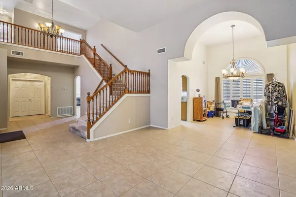 a view of staircase with lots of frames on wall and a window