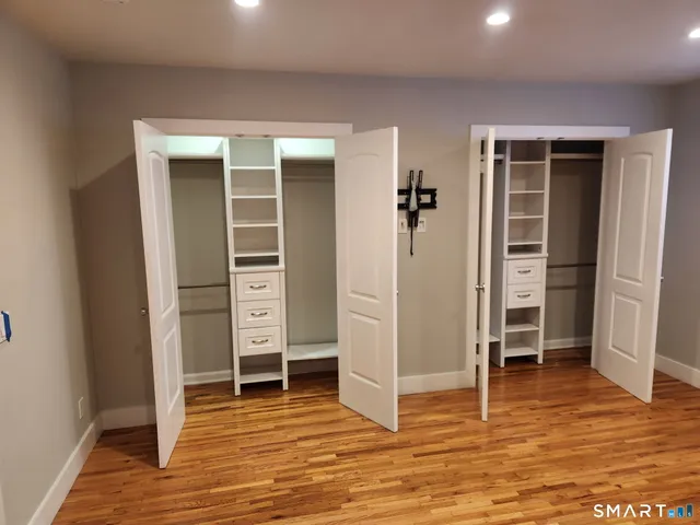 an empty room with wooden floor and closet