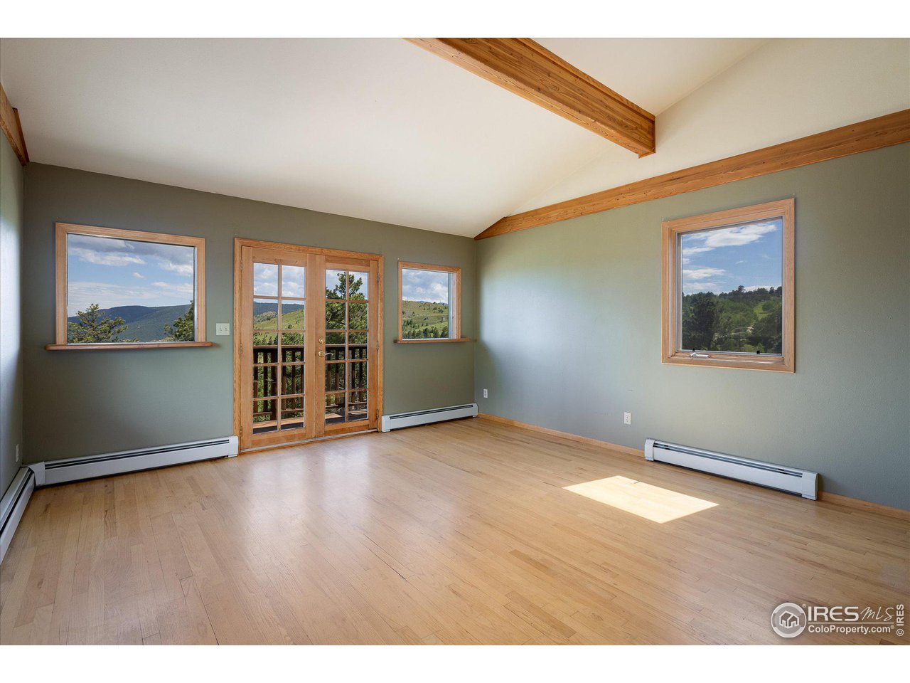 78 Old Post Office Road Boulder, CO 80302 - Photo 12 of 25 an empty room with wooden floor and windows