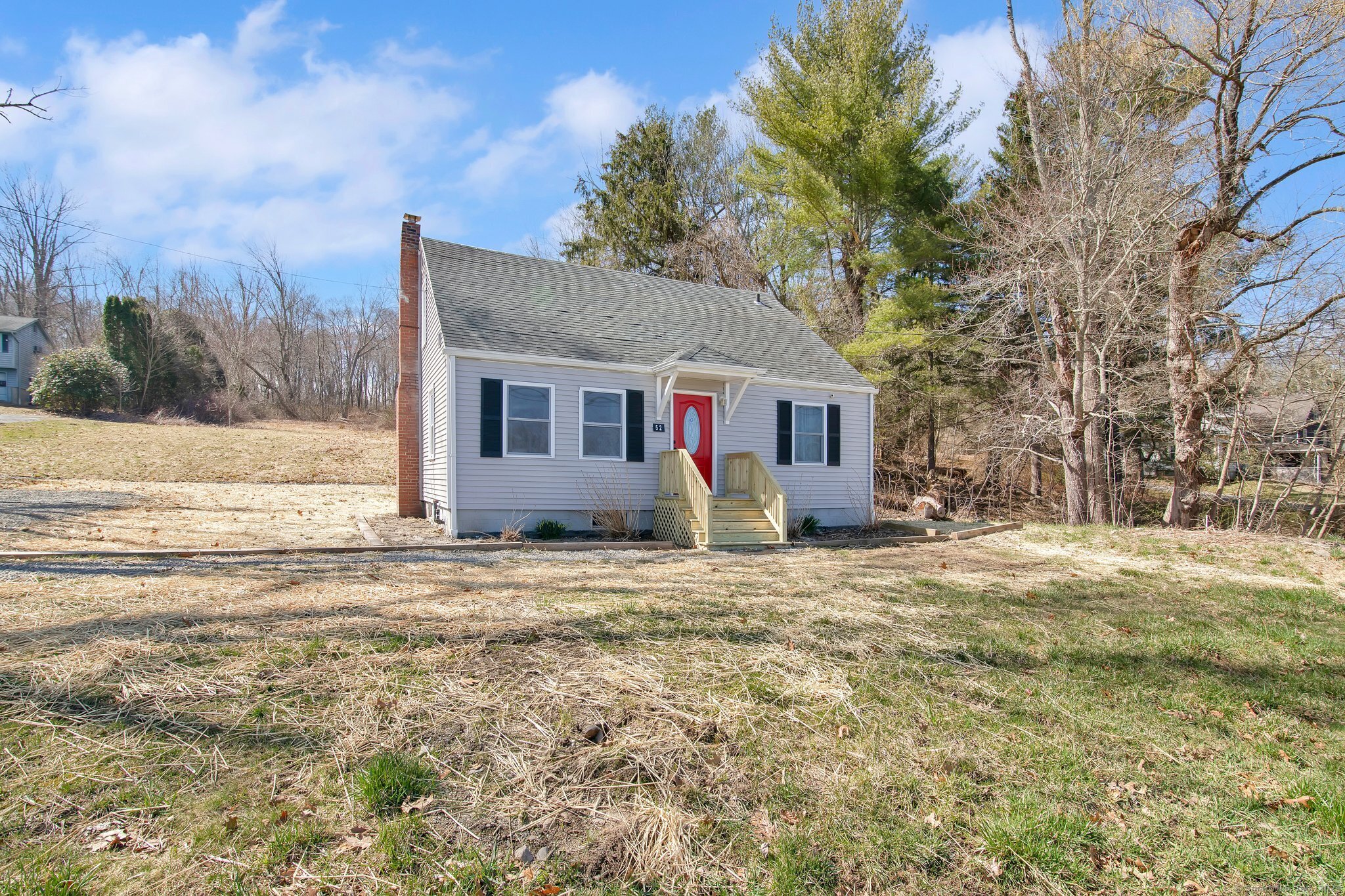 a view of a house with a yard and trees