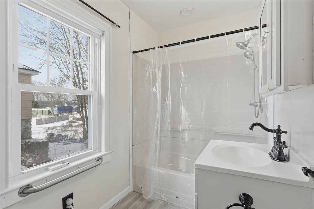 7 Mystic Street Methuen, MA 01844 - Photo 11 of 30 a bathroom with a sink a glass door shower and a mirror